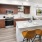 a kitchen with a large island and chairs