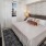 a bedroom with a bed and a fan