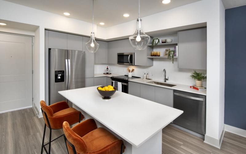 a kitchen with an island and chairs